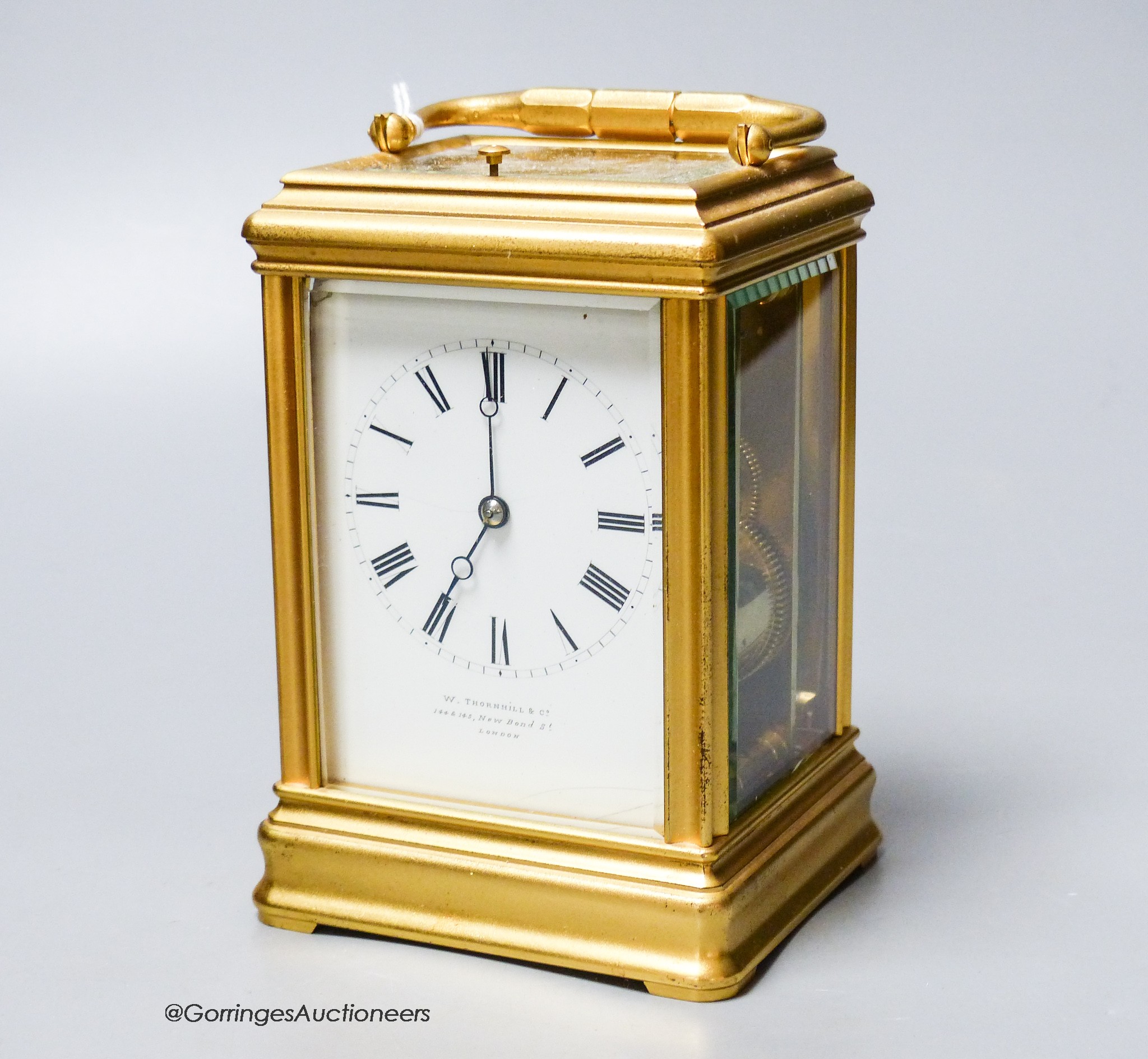 A large French brass repeating carriage clock, retailed by W. Thornhill & Company, 144 & 145 New Bond St, London, 15cm high., with case